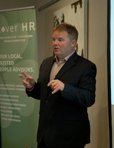 Man giving a presentation for Clover HR