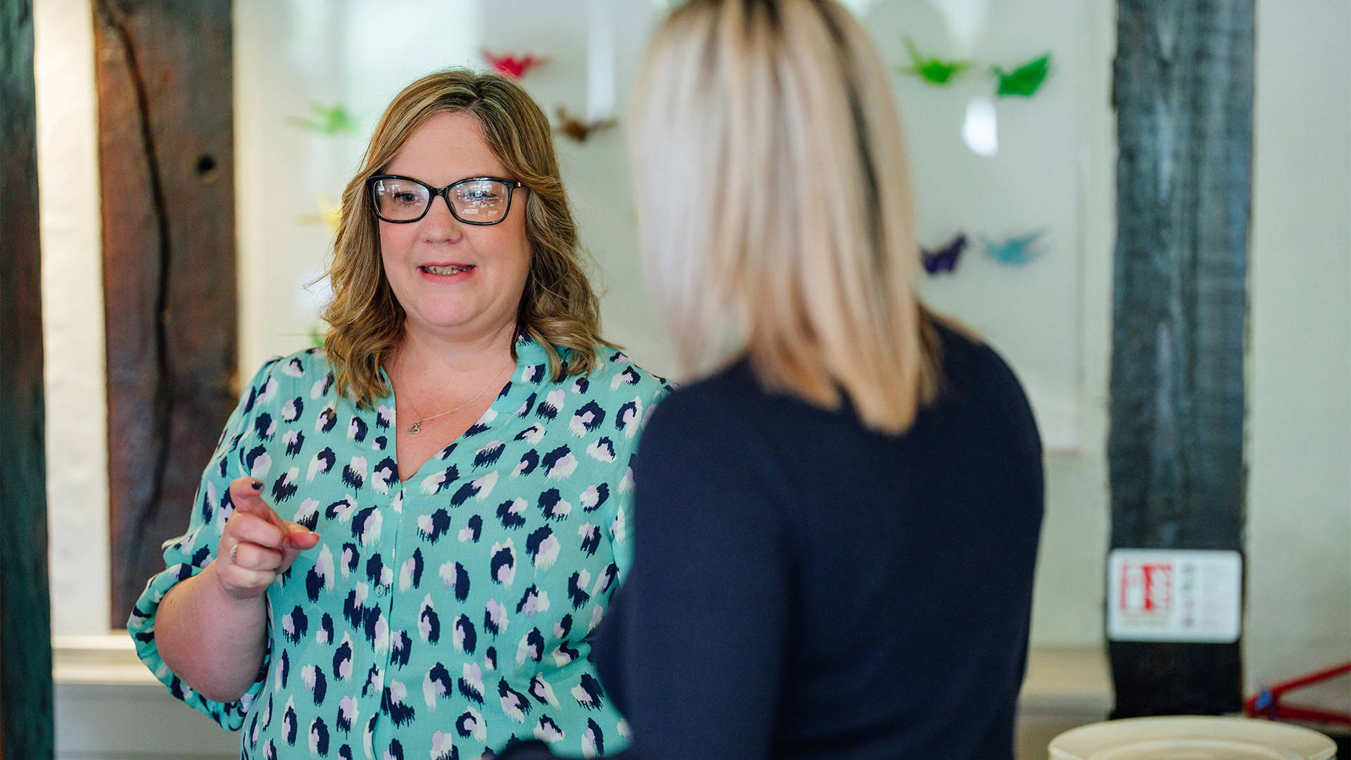 business-hr-header-feature team members talking at an event
