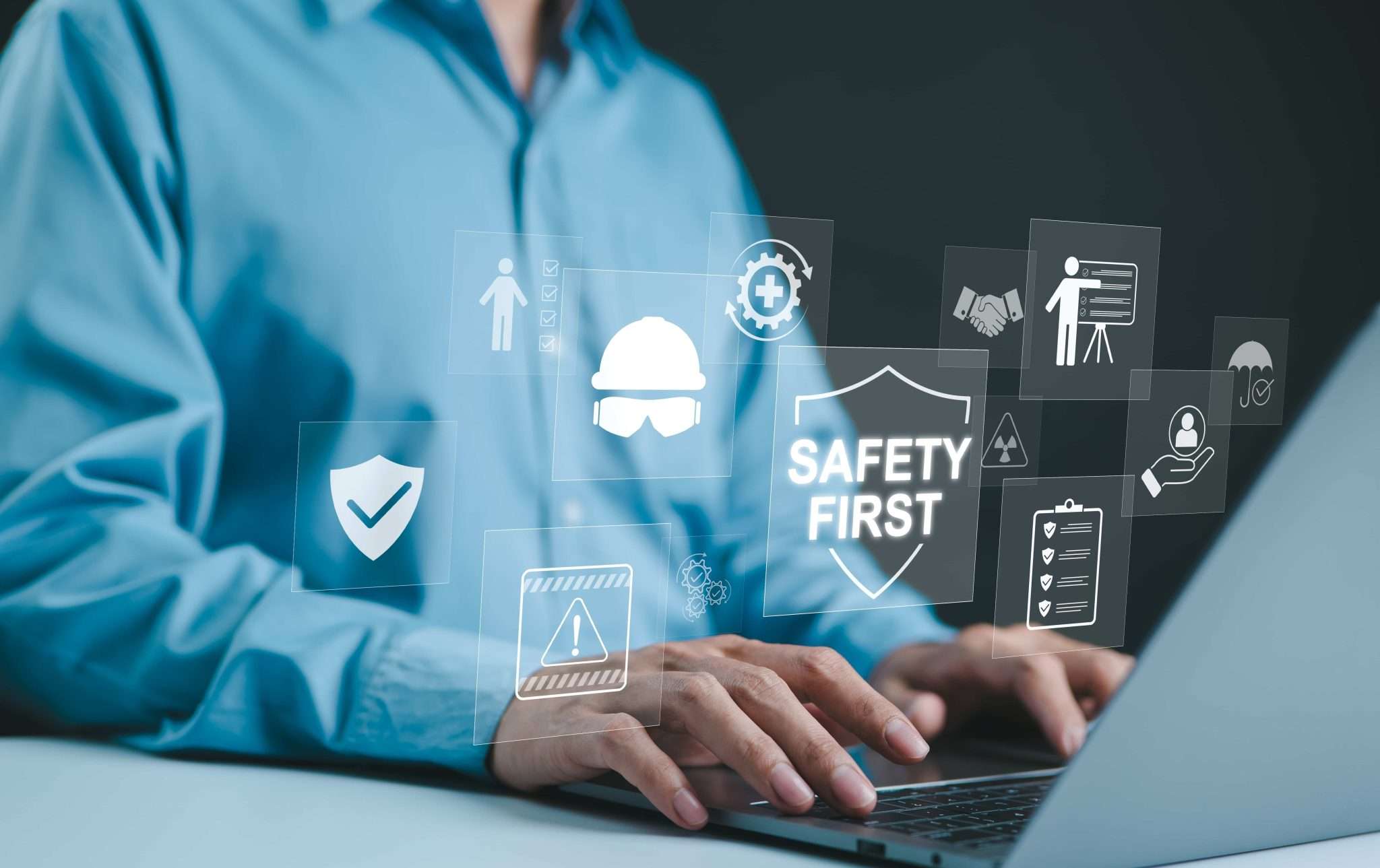 Person sat at a laptop with health and safety icons