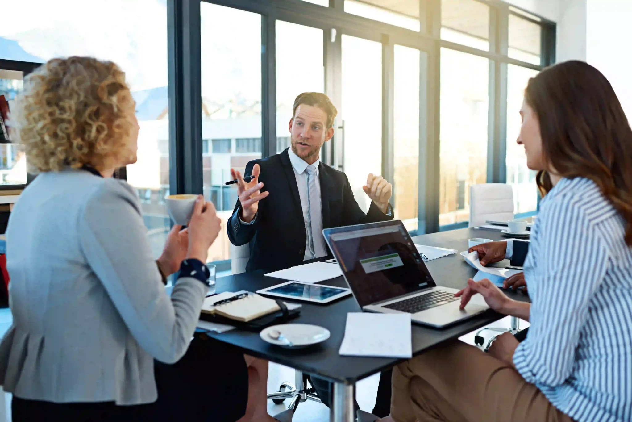 Lawyers meeting at a table to discuss strategy and legal advice.