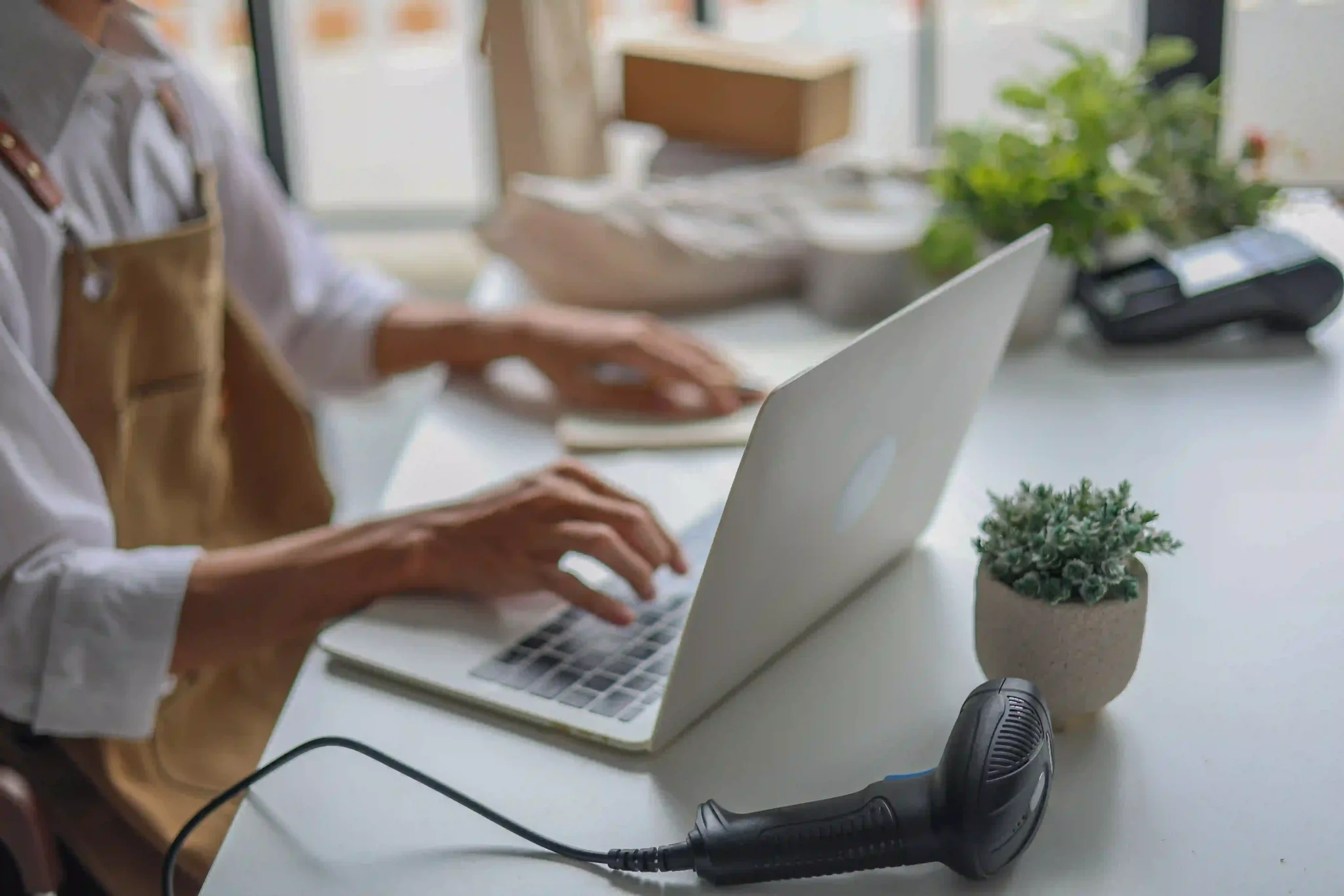 A retailer working on a laptop managing orders for startup or an online business.