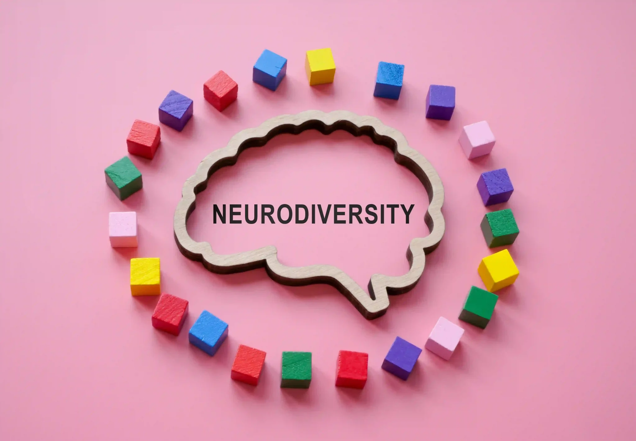 The outline of the brain with the inscription neurodiversity is surrounded by colored cubes.